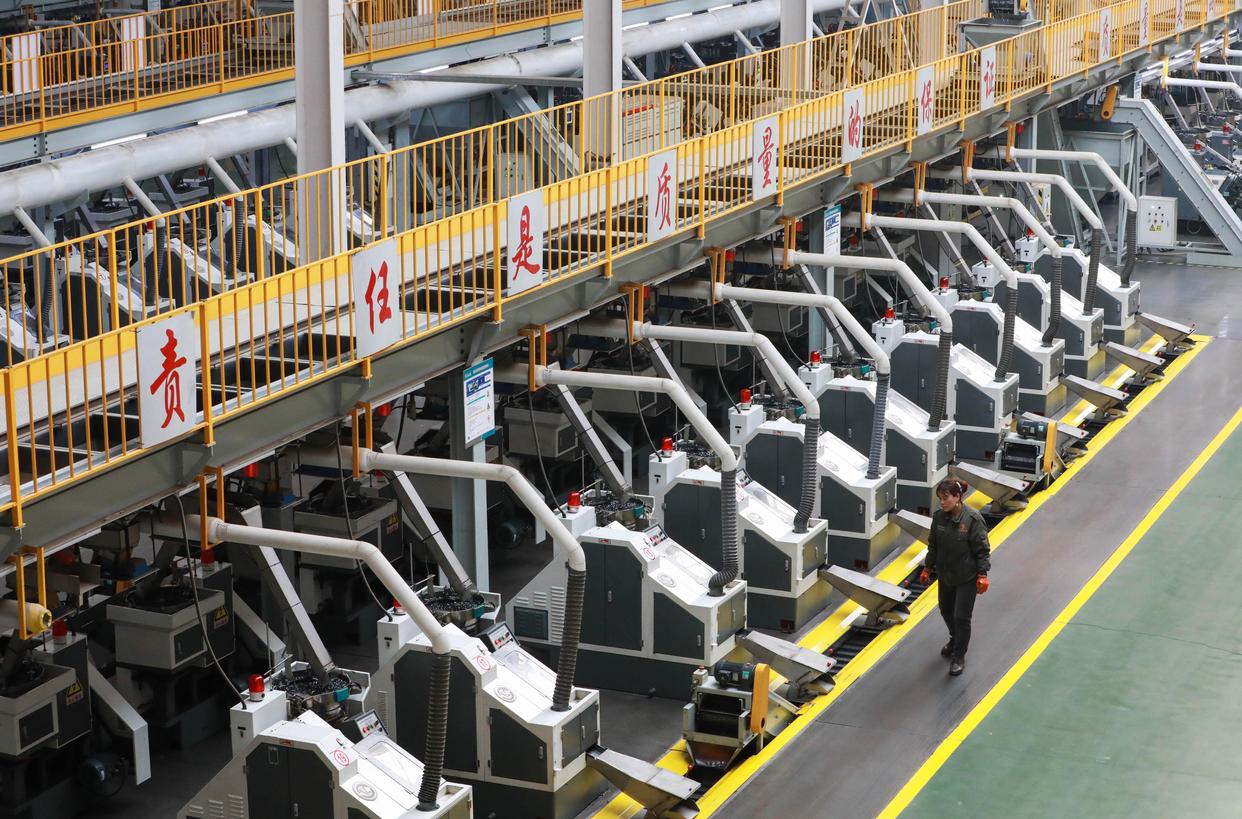 Fastener factory production floor with cold heading machines and heat treatment for high strength structural bolts